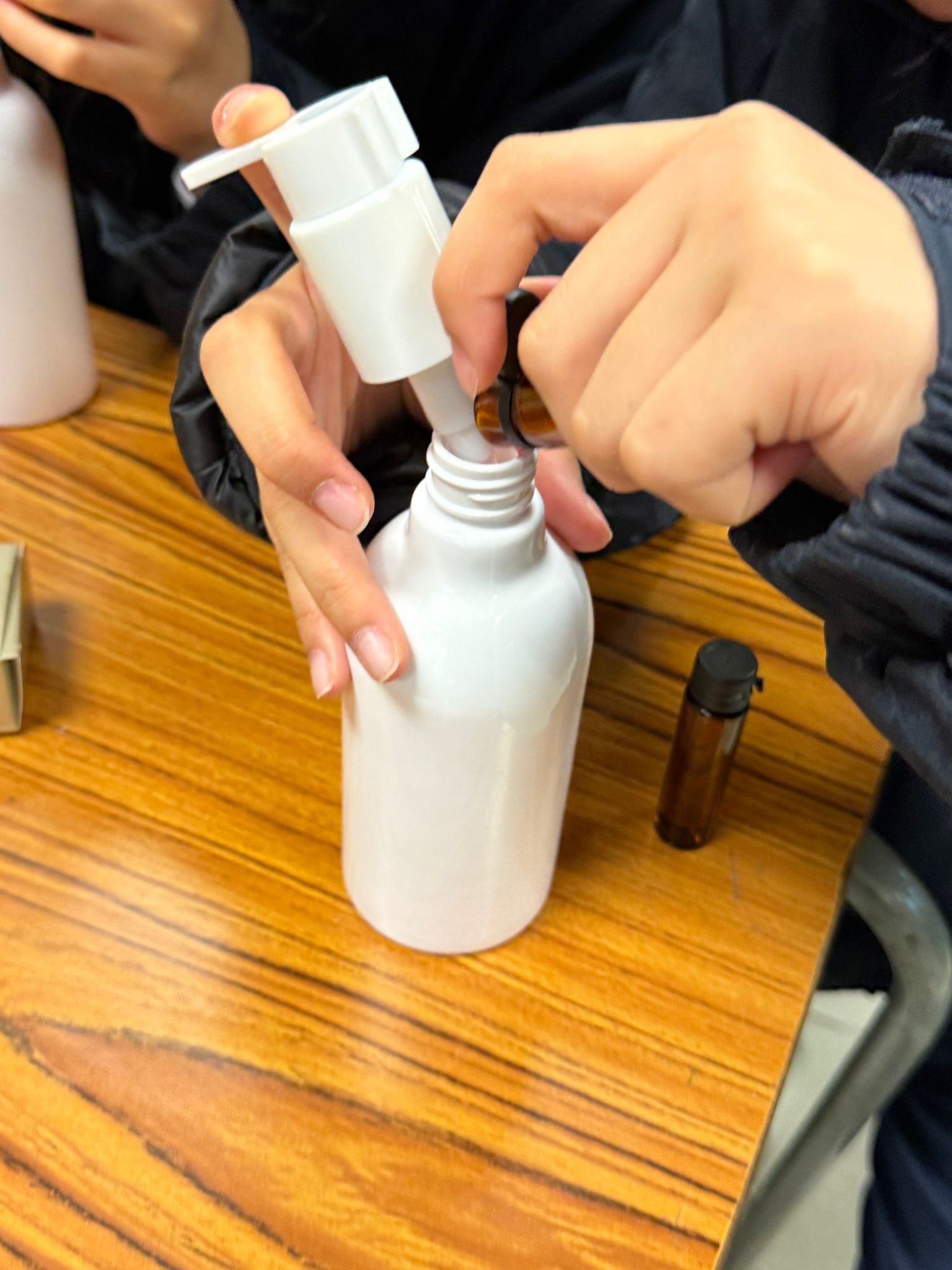 Student formulating a 100% personal shampoo with a dropper